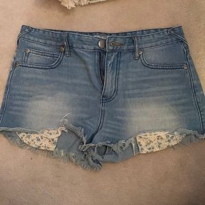 Free people highwaisted denim shorts with floral peek out pockets